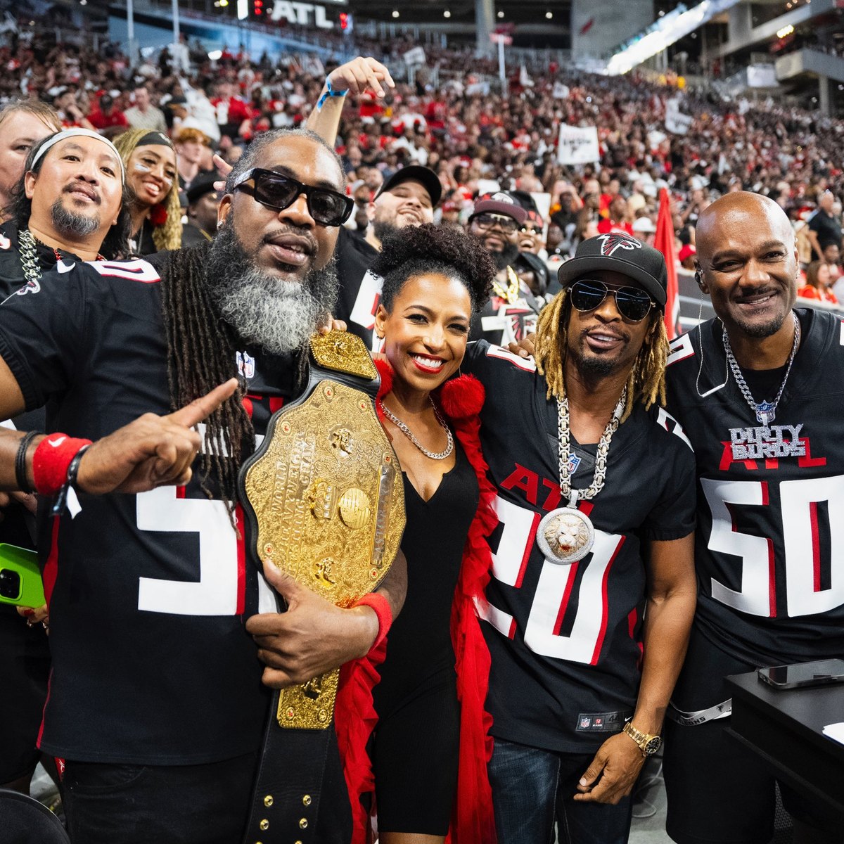 Chelsea celebrating with Falcons fans in the packed stands at Mercedes-Benz Stadium