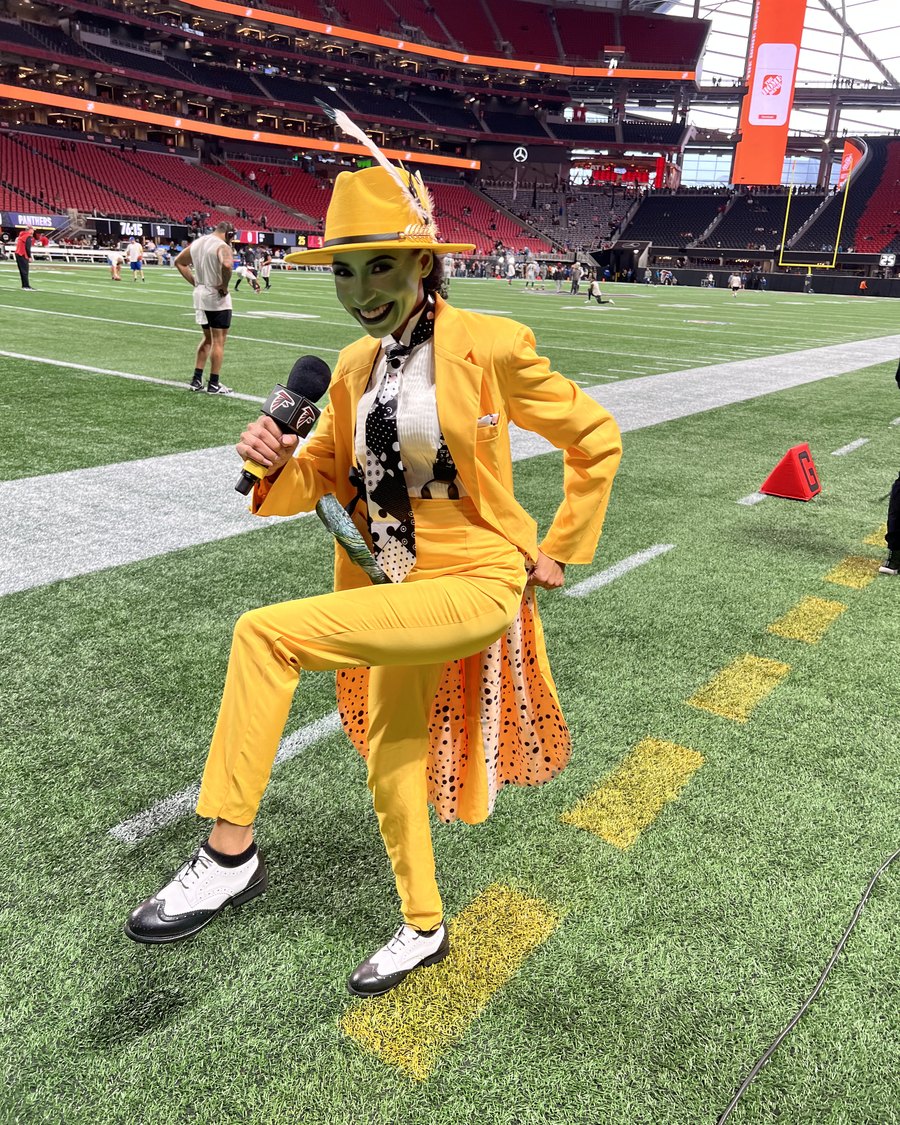 Chelsea striking a pose on the Falcons field in a custom yellow suit and hat