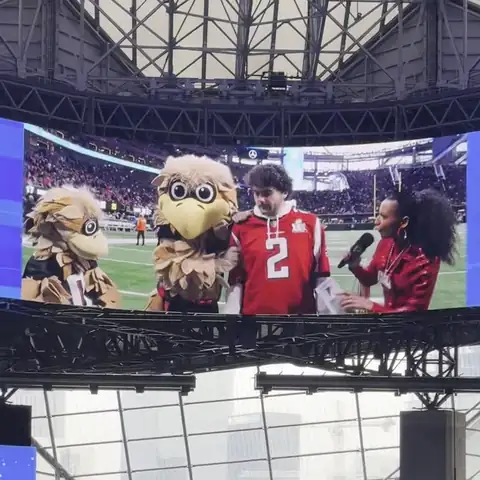 Looping clip: Chelsea live on the Mercedes-Benz Stadium jumbotron, then the view pans down to her on-field segment