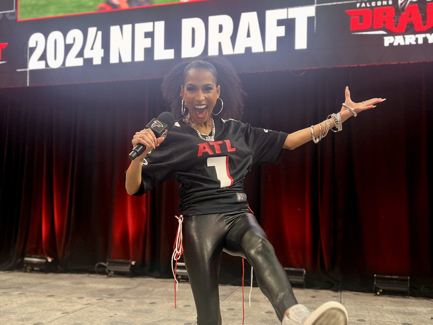 Chelsea mid-pose on the 2024 NFL Draft party stage at Mercedes-Benz Stadium