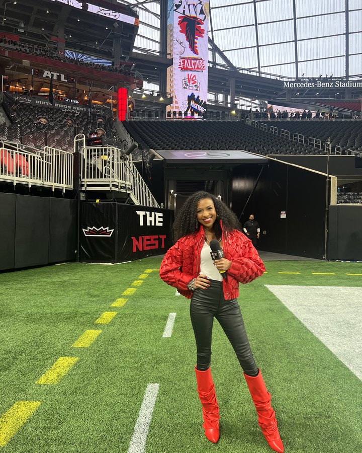 Chelsea on the field at Mercedes-Benz Stadium in a red jacket and boots